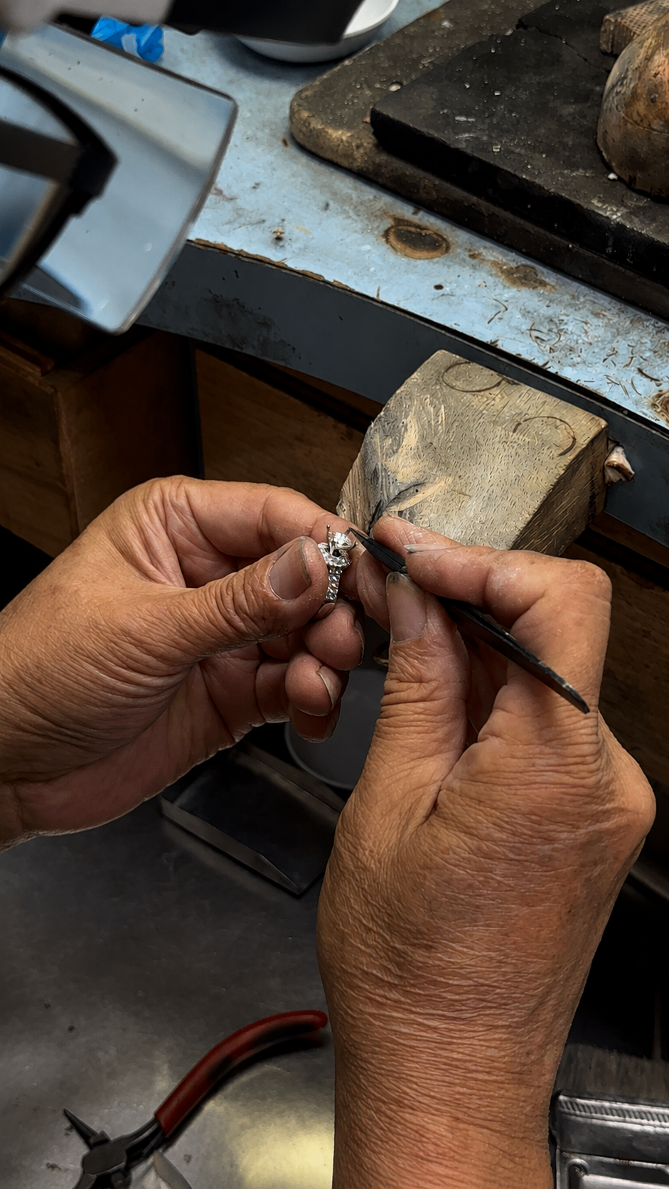 Hung Phat jeweler setting a diamond ring at the bench
