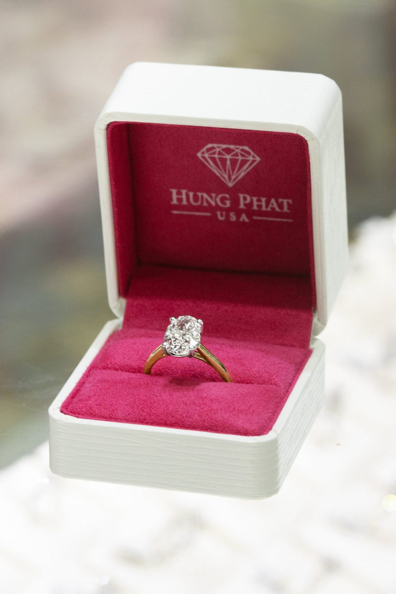 Oval diamond solitaire in a white Hung Phat box lined in pink velvet